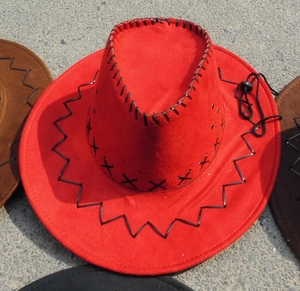 Detail of red faux suede cowboy hat featuring black contrast stitching and chin strap