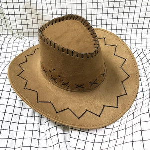 Detail of brown suede cowboy hat with black decorative hand-stitched seams and wide brim
