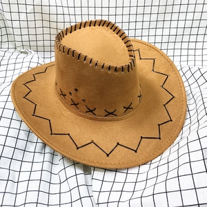 Close-up of brown suede cowboy hat featuring decorative cross-stitch detailing