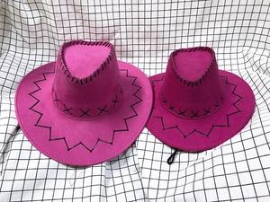 Detail of rose pink suede cowboy hats with bold black stitching on checkered background