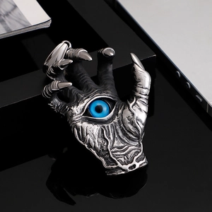 Gothic silver dragon claw pendant with a striking blue evil eye on black background