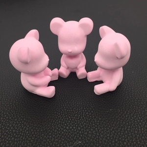 Three pink matte bear figurines arranged on a black leather surface for DIY resin art