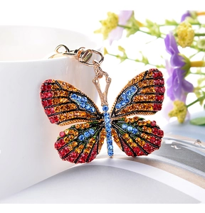Macro detail of luxury butterfly keychain with multi-color rhinestones and golden lobster clasp