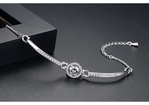 Macro shot of silver bracelet with a central round zircon and pavé setting details