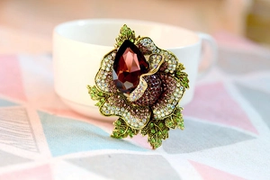 Macro shot of vintage crystal floral brooch with teardrop stone and gold plating