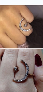 Macro detail of adjustable crescent moon and star ring with sparkling crystal pave setting