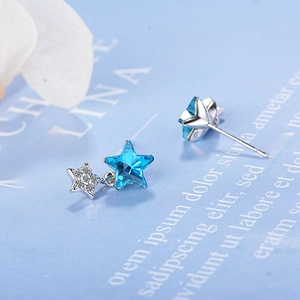 Elegant blue crystal star stud earrings with silver sparkles on artistic background