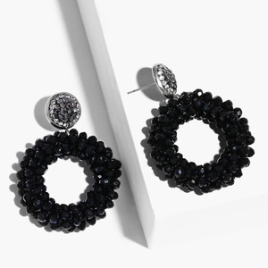 Detailed shot of black woven crystal beads hoop earrings with sparkling silver diamond accents