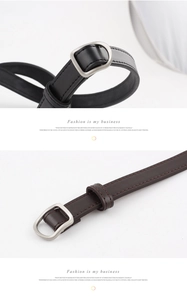 Detail of slim leather belts in black and brown with silver metal D-ring buckles