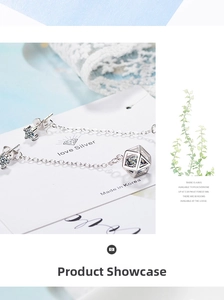 Detailed view of long geometric cube earrings with sparkling rhinestones and delicate silver chain