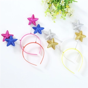 Glitter star headbands in pink blue silver and gold on springs with floral background