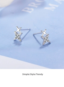 Macro shot of polished S925 silver double star earrings with shimmering cubic zirconia