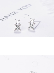 Macro shot of silver double star stud earrings with tiny cubic zirconia settings