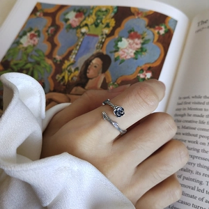 Detailed close-up of a vintage 925 sterling silver rose ring worn on a finger