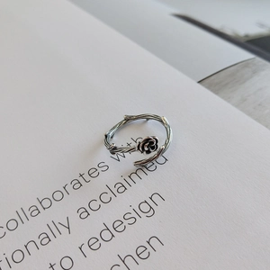 Macro detail of vintage S925 sterling silver rose vine ring with oxidized finish