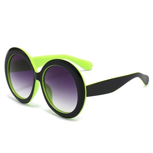 Lunettes de soleil rondes oversize avec monture vert néon et noir et verres dégradés violets