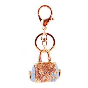 Exquisite golden handbag keychain with blue enamel flowers and sparkling pink crystals