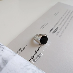 Detailed macro view of S925 sterling silver ring with black drip glue inlay and hallmark
