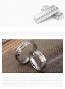Detail view of steel matte couple rings in 316L stainless steel on wood texture