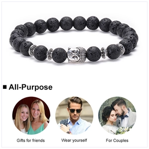 Detailed close-up of volcanic lava stone beads and silver Buddha head on an energy bracelet