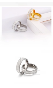 Detail of 6mm stainless steel rings in gold and silver with zircon inlays and 7g weight