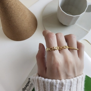 Close-up of golden hollow chain ring on model hand with elegant lifestyle background