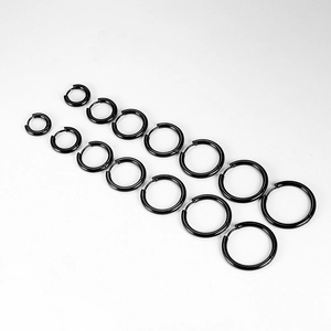 Macro view of 6 pairs of black stainless steel hoop earrings in various diameters