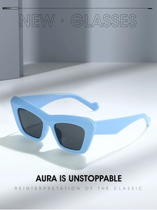 Detail of light blue triangular cat-eye sunglasses with matte finish and gray lenses