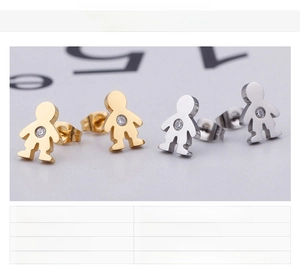 Macro view of gold and silver boy-shaped titanium steel earrings with zircon inlay