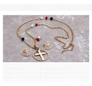 Detail of gold stainless steel cross necklace and earring set with colorful beads