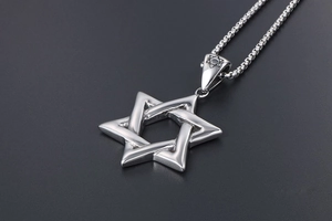Macro shot of silver titanium steel hexagram pendant with vintage hollow out design