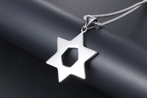 Close-up of vintage hollow hexagram pendant on silver stainless steel necklace chain