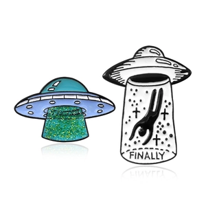 UFO spaceship enamel pins featuring green glitter and creative FINALLY letter design