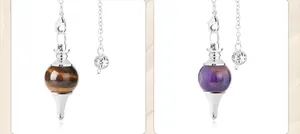 Detailed close-up of tiger eye and amethyst crystal pendulums with silver metal chains