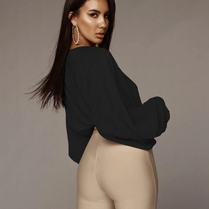Detail shot of black pleated V-neck jumpsuit showing soft texture and elegant loose sleeve