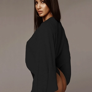 Detail view of a black long-sleeved jumpsuit featuring a unique back slit design for women