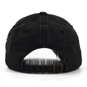 Detail of vintage washed black cotton baseball cap with adjustable bronze metal buckle