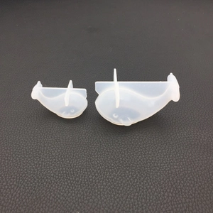 Close-up of two translucent whale-shaped silicone molds for DIY resin and plaster crafts