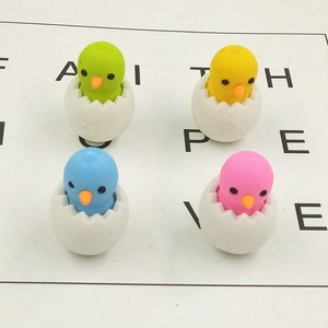 Set of four cute chick-in-eggshell erasers in pastel colors on a white background