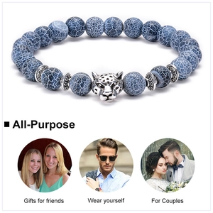 Detail of blue textured agate beads and silver alloy leopard head charm bracelet
