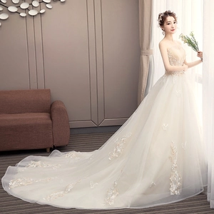 Elegant champagne lace off-shoulder wedding dress with a long floral embroidered trail