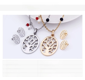 Detail of oval Tree of Life jewelry set with white crystals in gold and steel finish