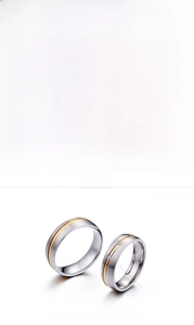 Detail showing two-tone stainless steel couple rings with cubic zirconia and brushed finish