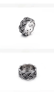 Detail view of 10mm woven stainless steel ring with white zircons and water-drop cutouts