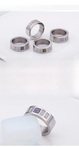 Close-up of wide stainless steel rings featuring colorful square resin stones and side zircons