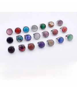 Macro view of stainless steel rings with colorful opal and turquoise stone inlays