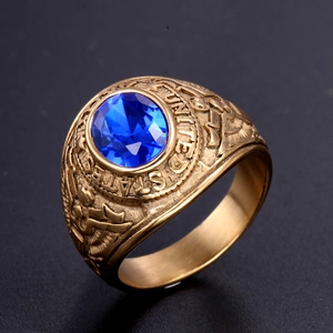 Macro view of gold stainless steel military ring with blue stone and eagle engraving