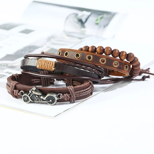 Set of 4 vintage braided leather bracelets for men featuring motorcycle metal charms