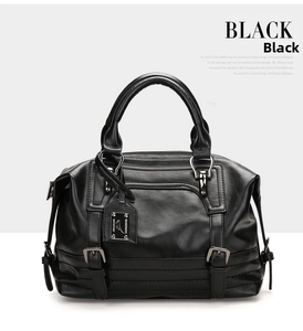 Close-up of black Boston handbag showing leather texture and silver buckle details