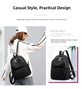 Detailed view of a black quilted nylon backpack featuring elegant gold zippers for women
